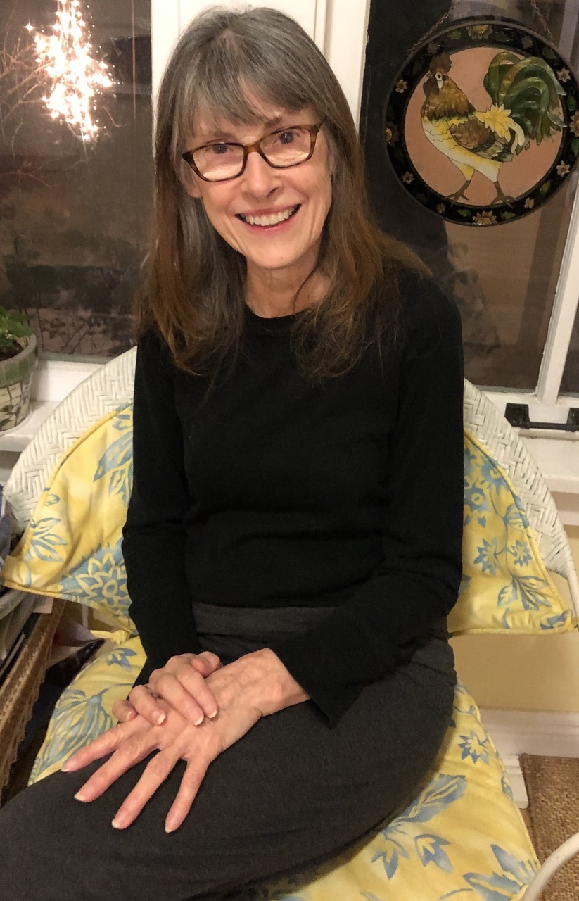 Mary Helen Stefaniak sits on her screened porch with a copy of her third novel, The World of Pondside, newly released by Blackstone Publishing in April 2022. Her book of short essays, The Six-Minute Memoir, will be released in fall 2022.